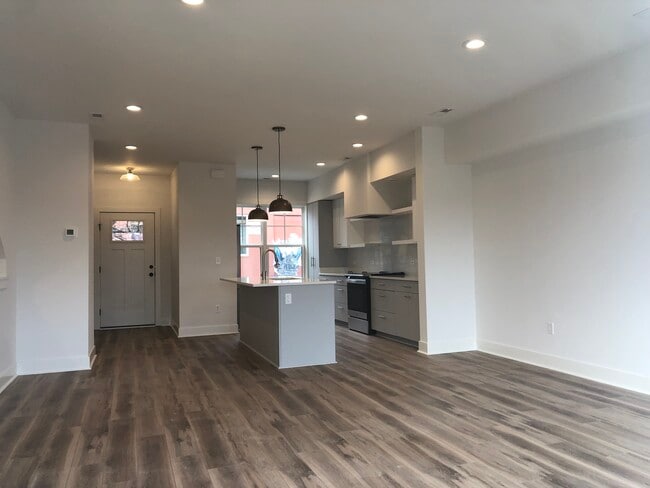 Open floor plan with kitchen island, stainless steel appliances and living and dining areas - 510 Court St