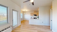 Located at 2700 Pierce Pkwy in Springfield, Oregon, this single-floor, 3-bedroom, 2-bathroom home offers a clean, modern design with a practical and efficient layout. Light wood laminate flooring runs throughout, creating a bright and cohesive aesthetic across the entire space.

The open-concept living and kitchen area serves as the heart of the home. The kitchen features light wood cabinetry with matte black hardware, white countertops, and black appliances including a range, microwave, and refrigerator. A peninsula counter divides the kitchen from the living area. A ceiling fan and chandelier provide layered lighting, while a sliding glass door allows natural light to pour in and provides outdoor access.

The dining area benefits from a picture window framing scenic mountain and landscape views, illuminated by a modern multi-bulb chandelier overhead.

The three bedrooms are bright and simply appointed, each with large windows bringing in natural light and views of the surrounding neighborhood. The primary bedroom includes a ceiling fan and window with outdoor views.

The two bathrooms offer distinct designs — one features a walk-in shower with white surround and chrome fixtures, while the other includes a tub-shower combo with a patterned tile floor, wood vanity with white countertop, and neutral warm tones throughout.