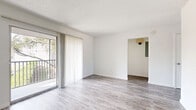 Located at 693 Wymore Road in Altamonte Springs, FL, this 2-bedroom, 1-bathroom residence offers a well-organized single-floor layout designed for comfortable everyday living. The open-concept living, dining, and kitchen area forms the heart of the home, bathed in natural light from a large sliding glass door that leads to a private balcony with outdoor views. The living area features wood-style plank flooring and a textured ceiling, creating a clean and bright atmosphere throughout.

The kitchen is well-appointed with white shaker cabinetry, dark granite countertops, a decorative tile backsplash, and a full suite of stainless steel appliances including a range, microwave, and dishwasher. A breakfast bar with a built-in countertop overhang provides a casual dining option and connects seamlessly to the dining area, which benefits from natural light via a window overlooking greenery.

The spacious primary bedroom includes multiple closets and a sliding glass door opening to its own outdoor area. The second bedroom is bright and functional, featuring a window that fills the room with natural light. The bathroom is tastefully updated with a warm wood vanity, marble-style countertop, a round mirror, and modern lighting fixtures. Additional conveniences include dedicated laundry, pantry, and ample closet storage throughout.