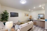 Located at 775 S Belmont St in Delano, CA, this single-story, 2-bedroom, 2-bathroom home offers a thoughtfully designed layout with modern finishes throughout. The open-concept living and dining area is bright and welcoming, featuring light wood-style flooring, recessed lighting, and a window that invites natural light. The living space flows seamlessly into the dining area and kitchen, making it ideal for everyday living and entertaining.

The kitchen is well-equipped with light wood cabinetry, white countertops, stainless steel appliances including a gas range, dishwasher, and refrigerator, along with a clean tile backsplash and wood-style flooring that continues from the main living area.

The primary bedroom is generously sized, featuring plush carpeting, a ceiling fan, and a walk-in closet with full-wrap shelving and hanging rods. The second bedroom also features carpeting, a window with natural light, and wall-mounted TV capability. Both bathrooms are finished with wood-tone vanities, wood-style flooring, and tub-shower combinations. A hallway connects the bedrooms and bathrooms, with a total of three closets across the home providing excellent storage. The overall aesthetic is clean, contemporary, and functional.