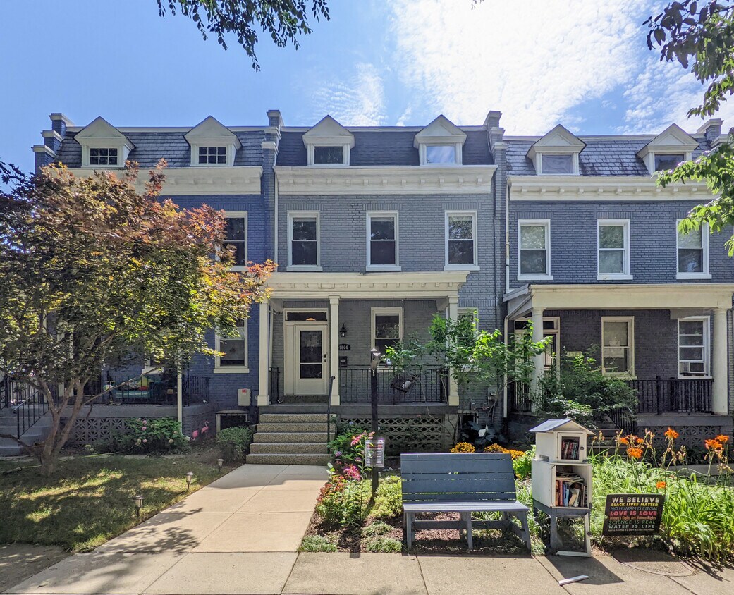 Cheerful front landscaping makes for a beautiful view from the front porch swing. - 4606 Iowa Ave NW