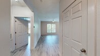 This contemporary apartment offers 980 square feet of thoughtfully designed living space. The open-concept floor plan seamlessly integrates the living room and kitchen, creating an ideal area for both relaxation and entertainment. The gourmet kitchen is equipped with stainless steel appliances, ample cabinetry in a two-tone design, and a stylish backsplash, perfect for culinary enthusiasts.

Both bedrooms are generously sized, with the primary bedroom boasting 190 square feet of space. Large windows in each room provide abundant natural light and picturesque views. The two full bathrooms feature modern fixtures, including a combination tub-shower in one and a sleek walk-in shower in the other.

The apartment includes an in-unit laundry room with full-sized washer and dryer, adding convenience to daily living. Throughout the space, neutral tones and wood-look flooring create a warm and inviting atmosphere. The overall design emphasizes functionality and comfort, making this apartment an ideal home for those seeking a contemporary living experience.