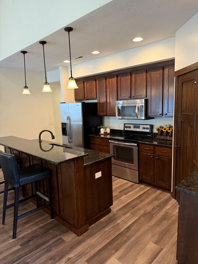 stainless steel appliances and garbage disposal - 98 Tribute Ave
