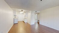 Located at 881 Soft Wind Rd in Vista, California, this single-floor residence offers a clean, functional layout with a welcoming atmosphere throughout. The living area is anchored by warm hardwood-style flooring that extends through the main spaces, large windows that invite natural light, and a textured ceiling that adds subtle character. A ceiling fan keeps the room comfortable, while the open flow into the kitchen makes the area feel connected and versatile.

The galley-style kitchen is well-appointed with white cabinetry offering generous storage, a full suite of white appliances including an electric range and refrigerator, and a double-basin sink. The layout is efficient and practical, with ample counter space running along both sides.

The bedrooms are carpeted for comfort and feature textured ceilings and windows with views of surrounding greenery, bringing a sense of calm and connection to the outdoors. Each room provides a quiet, neutral backdrop ready for personalization.

The bathroom is bright and clean, featuring a wide vanity with white cabinetry and a large mirror, a tub-shower combination, and hardwood-style flooring that ties in with the rest of the home. Overall, this residence presents a straightforward, well-maintained living environment in a convenient Vista location.