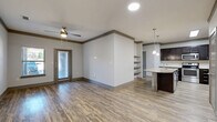 Located at 4651 S Custer Rd in McKinney, TX, this well-appointed 2-bedroom, 2-bathroom residence offers a thoughtfully designed single-floor layout. The open-concept living, dining, and kitchen area serves as the heart of the home, featuring wood-look flooring, crown molding, and a ceiling fan. Natural light filters in through windows and a glass-panel door leading to the private patio.

The kitchen is a standout, equipped with dark espresso cabinetry, granite countertops, stainless steel appliances, a built-in wine rack, subway tile backsplash, and a curved kitchen island with a sink and pendant lighting overhead. A pantry provides additional storage convenience.

The spacious primary bedroom includes plush carpeting, a ceiling fan, and a generous walk-in closet with wire shelving. The primary bathroom features wood-look tile flooring, a glass-enclosed shower, dark vanity cabinetry, and granite countertops. The second bedroom is carpeted and includes a double-door closet and natural light from a large window. A dedicated laundry room houses a full-size washer and dryer. With four closets and a utility room, this residence offers ample storage throughout.