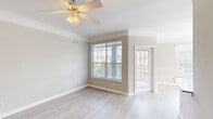 Located at 2951 Satellite Blvd in Duluth, GA, this well-appointed 2-bedroom, 3-bathroom residence offers a thoughtfully designed single-floor layout. The open kitchen is a standout feature, showcasing granite countertops, white cabinetry with brushed nickel hardware, and stainless steel appliances including a refrigerator, range, microwave, and dishwasher. Light wood-style flooring runs through the kitchen and connects seamlessly to the dining area, which is brightened by large windows and accented with crown molding and a pendant light fixture. The living room features a ceiling fan, crown molding, and a large window that fills the space with natural light. A second carpeted living or flex space includes a ceiling fan and French doors that open to the outdoors. The spacious primary bedroom offers plush carpeting and generous proportions. The bathrooms are finished with granite-topped white vanities and hardwood-style flooring, with tiled tub-shower combinations. A dedicated laundry room houses a full-size washer and dryer with overhead shelving for added storage. Two closets and three hallways further enhance the functional layout of this clean, neutral-toned residence.