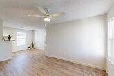 Located at 600 E Little York Rd in Houston, TX, this single-floor, 2-bedroom, 1-bathroom home offers a practical and well-designed layout. The combined living and dining area is bright and open, featuring light wood-look laminate flooring, neutral white walls, a textured ceiling, and a ceiling fan with light fixture that promotes airflow and comfort. Natural light filters in through multiple windows, creating a welcoming atmosphere throughout the shared space.

The galley-style kitchen is efficiently arranged with warm wood-toned cabinetry lining both sides, gray laminate countertops, a double-basin sink, and black appliances including a range, microwave, and refrigerator. A skylight panel above adds extra brightness to the workspace.

Both bedrooms are carpeted and include ceiling fans. The spacious primary bedroom offers ample room, while the second bedroom provides a comfortable and functional space. Three closets are distributed throughout the home, offering generous storage. The full bathroom features a tub/shower combination with large-format tile surround and wood-look flooring.

A private patio rounds out the home, providing an outdoor retreat. With its clean, neutral finishes and thoughtful layout, this home is move-in ready.
