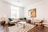 Located at 28 Voorhees Ave in Somerset, NJ, this two-floor residence offers a thoughtfully designed interior with contemporary finishes throughout. The open-concept kitchen is a standout feature, showcasing granite countertops, a large center island with an undermount sink, warm wood cabinetry, subway tile backsplash, and stainless steel appliances including a gas range and built-in microwave. Pendant lighting adds a stylish touch above the island, while rich hardwood flooring flows seamlessly through the main living areas. The living room is bright and inviting, with large windows that allow generous natural light and views of the surrounding area. Multiple bedrooms are finished with plush carpeting and feature ample natural light from well-placed windows. At least one bedroom includes a generous walk-in closet with built-in wire shelving. The bathrooms are clean and modern, with one featuring a spacious vanity with white cabinetry, black hardware, tile flooring, and a combination tub and shower with mosaic tile detailing. A secondary bathroom provides a streamlined layout with a dedicated water closet. Throughout, the space maintains a neutral, light-filled palette that creates a calm and functional living environment across both floors.