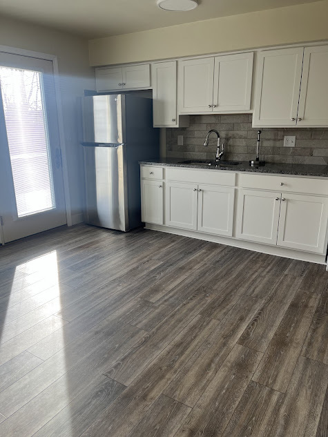 Kitchen with new refigerator and cabinets - 122 3rd St