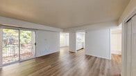 Located at 2329 Timberbrook Dr SE in Grand Rapids, Michigan, this two-bedroom, one-bathroom single-floor home offers a clean, functional layout with a welcoming sense of openness. Warm wood-style flooring runs throughout the entire home, creating a cohesive and easy-to-maintain aesthetic.

The living room is generously sized and filled with natural light, thanks to a sliding glass door that opens to the outdoors and offers views of surrounding greenery. It flows seamlessly into the dining area and connects to the kitchen, which features white cabinetry, a sink, and appliances including a stove and refrigerator.

Both bedrooms are well-proportioned and bright. The primary bedroom includes large windows framing lush tree views, providing a peaceful, nature-connected atmosphere. Each bedroom is equipped with sliding mirrored closet doors that conceal roomy storage areas. Additional closets throughout the home bring the total to four, offering excellent storage capacity.

The full bathroom is neatly appointed with a wooden vanity, a tub-shower combination, and clean white finishes. A dedicated laundry area adds everyday convenience. The overall design is characterized by neutral tones, white walls, and abundant natural light, creating a fresh and move-in-ready environment.