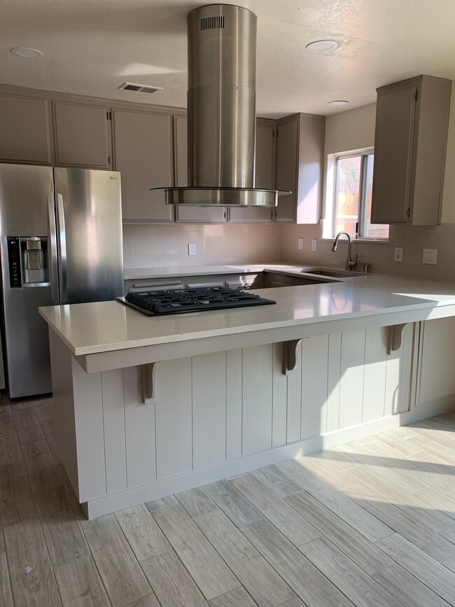 Kitchen with quartz countertop living roo - 325 W Howell Ave
