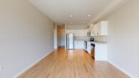 Located at Summerhill Place in Nanaimo, BC, this 1-bedroom plus den, 1-bathroom unit offers a well-designed layout with modern finishes throughout. Light-toned laminate flooring runs continuously across the main living areas, creating a cohesive and clean aesthetic. The open-concept kitchen and living area form the heart of the unit, with the kitchen showcasing crisp white cabinetry, light granite-style countertops, a full suite of stainless steel appliances including a refrigerator, electric range, over-the-range microwave, and dishwasher. Recessed pot lighting adds a polished touch overhead. The living area is bright and airy, benefiting from a large picture window that frames views of the surrounding neighbourhood and mountain backdrop. A private balcony extends the living space outdoors, offering open-air views of the mountains and greenery beyond. The spacious primary bedroom features a generous double closet with built-in shelving and a large window that continues the mountain view theme. The den provides a flexible secondary space suitable for a home office or additional storage. The bathroom is finished with a white vanity featuring a granite-style countertop, a tiled walk-in shower, and warm-toned tile flooring.