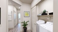 Located at Legacy Oak in Fort Worth, Texas, this thoughtfully designed 2-bedroom, 2-bathroom residence offers a well-appointed single-level layout with modern finishes and a comfortable, contemporary ambiance throughout. The open-concept kitchen and living area serves as the heart of the home, featuring dark espresso cabinetry, stainless steel appliances, a subway tile backsplash, and a central island with a white quartz countertop and bar seating — ideal for both casual dining and entertaining. Pendant lighting overhead adds a refined touch, while wood-style plank flooring extends seamlessly through the main living areas. The living room is bright and welcoming, with large windows dressed in sheer curtains that invite natural light, complemented by a ceiling fan overhead. Both bedrooms offer a calm retreat, with plush carpeting and ample natural light. The primary bedroom connects to a well-sized en-suite bathroom featuring a wide vanity with quartz countertops, dark wood cabinetry, a large mirror, and access to a spacious walk-in closet. The second bathroom mirrors the same refined aesthetic, complete with a tub-shower combination. A dedicated laundry area with full-size washer and dryer adds everyday convenience, rounding out this polished and functional home.