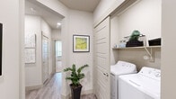 Located at Legacy Oak in Fort Worth, Texas, this thoughtfully designed 2-bedroom, 2-bathroom residence offers a well-appointed single-level layout with modern finishes and a comfortable, contemporary ambiance throughout. The open-concept kitchen and living area serves as the heart of the home, featuring dark espresso cabinetry, stainless steel appliances, a subway tile backsplash, and a central island with a white quartz countertop and bar seating — ideal for both casual dining and entertaining. Pendant lighting overhead adds a refined touch, while wood-style plank flooring extends seamlessly through the main living areas. The living room is bright and welcoming, with large windows dressed in sheer curtains that invite natural light, complemented by a ceiling fan overhead. Both bedrooms offer a calm retreat, with plush carpeting and ample natural light. The primary bedroom connects to a well-sized en-suite bathroom featuring a wide vanity with quartz countertops, dark wood cabinetry, a large mirror, and access to a spacious walk-in closet. The second bathroom mirrors the same refined aesthetic, complete with a tub-shower combination. A dedicated laundry area with full-size washer and dryer adds everyday convenience, rounding out this polished and functional home.