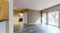 This 620 square foot, single-floor apartment at Lodge At Ames Pond offers a thoughtfully designed living space. The open-concept layout maximizes the use of space, creating a seamless flow between the living room and kitchen. The living area features wood-look flooring and large windows, allowing for abundant natural light. A unique yellow-painted alcove adds a pop of color and serves as a built-in storage or display area.

The kitchen is equipped with modern stainless steel appliances, dark wood cabinetry, and granite countertops. A stylish backsplash adds visual interest, while the galley-style layout ensures efficiency. The bedroom, measuring 160 square feet, includes a spacious closet with built-in organizers and is carpeted for comfort.

The bathroom boasts a combination tub and shower, dark wood vanity with a granite countertop, and distinctive multicolored slate flooring. Throughout the apartment, neutral wall colors provide a versatile backdrop for personal decor. The unit also features modern amenities such as central heating and air conditioning, ensuring year-round comfort in this well-appointed space.