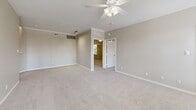 Located at 800 Lakeside Cir in Lewisville, TX, this single-story, 4-bedroom, 2-bathroom home offers a well-organized layout across one floor. The living room is a bright, open space anchored by a tile-surround wood-burning fireplace with a classic white mantel, complemented by plush carpet, a ceiling fan, and multiple windows that invite natural light. Adjacent to the living area, the kitchen is efficiently designed with gray raised-panel cabinetry, light quartz countertops, a subway tile backsplash, a double stainless steel sink, and white appliances including a refrigerator, electric range, and microwave. A breakfast bar adds casual dining convenience. The four bedrooms feature soft carpet flooring, ceiling fans, and neutral wall tones. Several bedrooms benefit from natural light through large windows with outdoor greenery views. The primary bedroom is a generously sized retreat with crown molding detail and a ceiling fan. Both bathrooms share a cohesive design, each featuring wood-look vinyl flooring, a tub/shower combo with a white tile surround, a single-sink vanity with gray cabinetry, and a mirrored medicine cabinet above. The home's consistent neutral palette and practical finishes create a clean, functional living environment throughout.