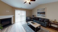 Located at 940 Center Rd in Buffalo, NY, this single-floor residence offers a thoughtfully designed layout that balances functionality and contemporary style. Warm neutral tones carry throughout the home, creating a cohesive and inviting atmosphere from room to room.

The living room features vaulted ceilings, a ceiling fan, and a sliding glass door that floods the space with natural light while providing access to the outdoors. The open layout flows naturally into the dining area, which is highlighted by light hardwood-style flooring, recessed lighting, and a large decorative mural wall that adds a striking artistic focal point.

The kitchen is well-equipped with rich dark cabinetry, granite countertops, stainless steel appliances including a range, microwave, and refrigerator, plus a central island with a double sink and pendant lighting overhead.

The bedroom features plush carpeting, vaulted ceilings, and wide windows dressed with sheer curtains that invite ample natural light. An additional room with carpeting and a ceiling fan serves well as a home office or secondary bedroom.

Both bathrooms are finished with granite-topped dark vanities and hardwood-style flooring. The primary bathroom includes a walk-in shower, while the secondary bathroom offers a full tub-shower combination.