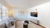 Located at 1295 Donnelly Ave SW in Atlanta, GA, this well-appointed one-bedroom, one-bathroom unit offers a thoughtfully designed single-floor layout that maximizes every square foot. The bright living room welcomes natural light through large windows with outdoor views, and features rich hardwood flooring, clean white walls, and a comfortable, open atmosphere ideal for both relaxing and entertaining. The kitchen is efficiently designed with white cabinetry, granite countertops, a subway tile backsplash, stainless steel sink, and black appliances including an electric range and refrigerator. A dedicated dining area adjacent to the kitchen provides a functional space for meals. A hallway connects the main living areas to the private bedroom, which is generously sized and features plush carpeting, a large window with outdoor greenery views, and ample room for furnishings. The full bathroom is clean and bright, finished with white tile surrounding a tub/shower combination and wood-look flooring. A dedicated in-unit laundry area with a stacked washer and dryer adds everyday convenience. Throughout the unit, a neutral color palette and consistent finishes create a cohesive and inviting ambiance.