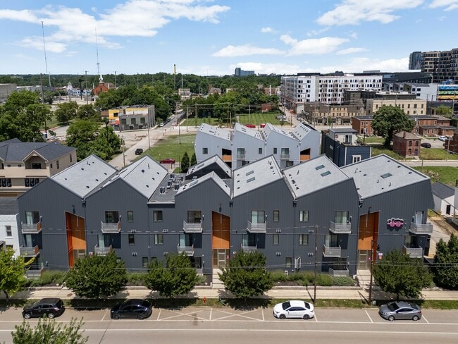 Modern urban apartment complex with unique angled rooftops - The Benjamin