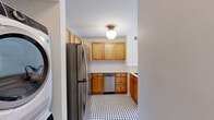 Located at 1437 Lucile Ave SW in Atlanta's West End neighborhood, this two-bedroom, one-bathroom unit offers a well-organized single-floor layout. Warm-toned hardwood floors flow throughout the living areas and bedrooms, lending a cohesive and inviting feel to the space. The living room is bright and open, with a large window that allows natural light to pour in, creating a welcoming atmosphere. A hallway connects the main living areas to the rest of the unit. The kitchen is a functional highlight, featuring warm maple cabinetry, light countertops, a classic black-and-white mosaic tile floor, and a full suite of stainless steel appliances including a refrigerator, range, microwave, and dishwasher. A peninsula provides additional counter space and a natural division between the kitchen and living area. Both bedrooms are well-proportioned, each outfitted with a ceiling fan, hardwood floors, and windows with blinds that offer natural light and outdoor views. The spacious primary bedroom includes a double-door closet, while the second bedroom also features closet storage. The bathroom includes a tiled tub-shower combination with warm beige tile surround, mosaic floor tile, and matte black fixtures, offering a clean and functional design.