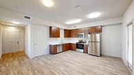Located at 1650 Huntington Dr in Roseville, CA, this one-bedroom, one-bathroom unit is thoughtfully designed to maximize functionality across a single floor. The open-concept layout seamlessly connects the living, dining, and kitchen areas, creating a cohesive and inviting common space. The kitchen is well-appointed with warm walnut-toned cabinetry, white countertops, and a full suite of stainless steel appliances including a refrigerator, range, microwave, and dishwasher. Light wood-style flooring runs throughout the main living areas, contributing to a bright and clean aesthetic. A dedicated pantry provides additional storage, while an in-unit laundry area adds everyday convenience. The bedroom features plush carpeting, a window with views of surrounding trees that fills the room with natural light, and a sliding closet with panel doors for ample storage. The hallway also includes a louvered bi-fold closet for extra organization. The bathroom is finished with a single-sink wood-toned vanity, a large mirror with built-in shelving, and a walk-in shower with integrated corner shelves. Clean white walls and consistent finishes throughout give the space a cohesive, modern feel.