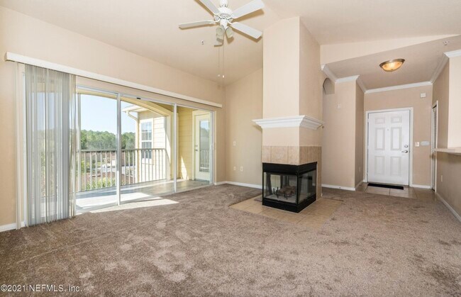 Family room w fireplace and sliding doors to screened terrace - 275 Old Village Center Cir
