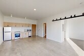 Located at 3740 Second St in Detroit's vibrant Midtown neighborhood, this 1-bedroom, 1-bathroom unit offers a clean, modern aesthetic defined by an open-concept layout and thoughtful industrial-inspired design. Polished concrete floors run throughout, lending the space a contemporary loft-like character that ties every room together seamlessly.

The combined living, dining, and kitchen area forms the heart of the unit. The kitchen features light wood cabinetry, stainless steel appliances including a gas range and dishwasher, and a built-in microwave — all arranged efficiently along one wall. A striking black sliding barn door serves as a bold architectural accent, separating spaces while adding an industrial edge to the otherwise clean, white interior.

The living area is bathed in natural light through large windows that frame views of the surrounding Detroit streetscape and neighboring brick architecture, creating a bright and airy atmosphere. The bedroom, accessed through its own door, is a cozy and well-lit retreat with a tall window that brings in additional natural light.

The bathroom features polished concrete floors, white subway tile in the walk-in shower, and a handheld showerhead fixture with brushed gold hardware. Additional conveniences include two closets and an in-unit laundry area, completing this efficiently designed and stylish urban residence.