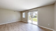 Located at 233 Country Walk Pl in Altamonte Springs, FL, this single-floor, one-bedroom, one-bathroom residence offers a thoughtfully laid-out living space with a clean, neutral aesthetic throughout. Light wood-style flooring runs consistently across all rooms, complementing the soft greige wall tones and bright white trim that create an airy, cohesive feel.

The living room is a standout, featuring both a large sliding glass door and an additional window that flood the space with natural light while offering views of lush tropical greenery outside. The sliding door provides direct outdoor access, enhancing the sense of openness.

The galley-style kitchen is well-appointed with warm honey-toned cabinetry, light stone countertops, and a full suite of stainless steel appliances including a refrigerator, dishwasher, and range with overhead ventilation. Ample upper and lower cabinet storage makes this kitchen highly functional.

The spacious primary bedroom offers generous proportions, a sliding-door closet, and easy hallway access to the full bathroom. The bathroom features a clean, full-size tub and shower combination with a simple, bright finish. A connecting hallway ties all rooms together efficiently, contributing to the home's practical and comfortable single-level layout.
