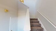 Located in Plano, TX, this three-story home offers four bedrooms and four bathrooms across a well-designed, multi-level layout. The ground floor provides an attached two-car garage with automatic openers, offering convenient and secure parking. The main living level features an open-concept kitchen and living room combination with light wood-look flooring and crown molding. The kitchen is outfitted with white shaker cabinetry, a subway tile backsplash, stainless steel appliances including a refrigerator, range, microwave, and dishwasher, as well as a central island with a white countertop. Adjacent to the kitchen, the living area includes a classically trimmed fireplace and large windows that invite natural light and outdoor views. The upper floor houses the majority of the bedrooms, including a generously sized primary bedroom with a dedicated en-suite bathroom featuring a soaking tub, separate shower, and white vanity. Additional bedrooms are carpeted and fitted with ceiling fans and ample closet space, including walk-in closets with built-in wire shelving. Two hallways connect the upper-level rooms, and the carpeted staircase with white railings links all three floors seamlessly. The home maintains a clean, neutral palette throughout.