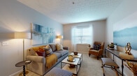 Located at 1350 Gage Street in Columbus, Ohio, this single-floor residence offers a thoughtfully designed layout that balances comfort and functionality throughout. The living room serves as the heart of the home, showcasing soft neutral-toned carpet, light blue accent walls, and a textured ceiling. A bright window with sheer curtains allows natural light to fill the space, creating a warm and inviting atmosphere. The open flow between the living area and kitchen makes the layout ideal for everyday living. The kitchen features warm honey-toned oak cabinetry extending to the upper walls, providing generous storage. White appliances—including a range, over-the-range microwave, refrigerator, and dishwasher—are complemented by light countertops and easy-care flooring. The kitchen also includes a peninsula that connects naturally to the dining area. The bedrooms are carpeted and serene, each offering closet space with built-in shelving and rods, and windows that bring in soft natural light. The bathroom is cleanly finished with a wood-toned vanity, white countertop, tiled flooring, and a built-in linen niche with shelving for convenient storage. Throughout the residence, neutral tones and consistent finishes create a cohesive, move-in-ready environment well-suited for comfortable living in Columbus.