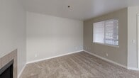 Located at 5700 S 129th St in Seattle, WA, this one-bedroom, one-bathroom unit offers a practical and comfortable layout across a single floor. The open living and dining area is a welcoming centerpiece, featuring plush wall-to-wall carpeting and a tile-surround fireplace that adds warmth and character to the space. Natural light filters in through windows fitted with blinds, and a ceiling fan enhances comfort in the adjoining area. The galley-style kitchen is efficiently designed with white cabinetry, light laminate countertops, a stainless steel sink, and white appliances, including an electric range. Wood-look flooring runs through the kitchen, which connects seamlessly to the dining area. A dedicated laundry area and a pantry provide excellent storage and convenience. The bedroom is generously sized, offering a sliding-door closet, a sun-filled window, and baseboard heating. The full bathroom includes a soaking tub and shower combination. Two closets throughout the unit offer ample storage. A private balcony provides outdoor access, completing this well-appointed Seattle residence.