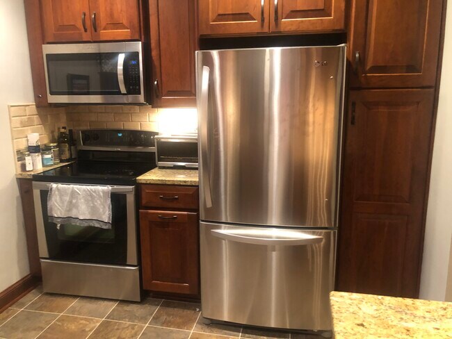 Kitchen with refrigerator, range and microwave. In cabinet garbage and pantry - 4119 N Newhall St