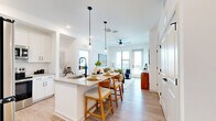 Located at 1701 N Florida Ave in Tampa, FL, this thoughtfully designed 4-bedroom, 2-bathroom residence offers a bright and contemporary living experience. The open-concept kitchen and living area serves as the heart of the home, featuring white shaker cabinetry, quartz countertops, stainless steel appliances, a large center island with pendant lighting, and a tile backsplash. Light wood-style flooring flows throughout, complementing the clean, white interiors. The living room is bathed in natural light from large windows and a glass door that opens to a balcony, offering sweeping views of the Tampa skyline. A ceiling fan adds comfort to both the living and primary bedroom spaces. The primary bedroom is generously sized, with large windows framing city views and an en-suite bathroom featuring a dual-sink vanity, quartz countertops, black hardware accents, and access to a walk-in closet. The second bathroom offers a single-sink vanity and a tub-shower combination. Three additional bedrooms provide flexible space, each with dedicated closets. A pantry and four total closets ensure ample storage. Light, neutral tones and modern black hardware details throughout create a cohesive, contemporary aesthetic well-suited for urban living in the heart of Tampa.