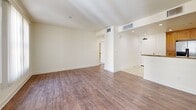 Located at 1905 Concord Blvd, Unit 303 in Concord, California, this two-bedroom, two-bathroom residence offers a well-organized single-floor layout with a comfortable and functional design throughout. The open-concept kitchen and living area serves as the heart of the home, where rich wood cabinetry, granite countertops, and a full suite of stainless steel appliances — including a refrigerator, range, microwave, and dishwasher — create a polished and practical cooking space. Light tile flooring flows through the kitchen, transitioning to warm hardwood-style flooring in the living room, which is brightened by a large window with vertical blinds. The spacious primary bedroom features dual windows that invite natural light and a generous walk-in closet with full-length hanging rods and carpeted flooring. The second bedroom also offers carpeted floors and a sliding glass door opening to an outdoor view. Each bathroom is finished with tile flooring, wood-accented vanities, and clean white fixtures — one featuring a shower-tub combo and the other a standalone glass-enclosed shower. Two hallways connect the rooms efficiently, while recessed lighting and neutral wall tones throughout lend the space a bright, cohesive ambiance.