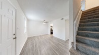 Located along SR-204 in Savannah, Georgia, this two-story residence presents a clean, updated interior with a neutral palette throughout. The main living areas are finished with light-toned luxury vinyl plank flooring that extends through the entry, living room, and additional flex spaces, lending a cohesive, modern feel to the lower level. Natural light enters through windows and full sliding glass doors, which open directly to a fenced outdoor area — a functional extension of the interior living space.

The kitchen is thoughtfully appointed with white shaker-style cabinetry, granite-patterned countertops, a classic white subway tile backsplash, a double stainless steel sink, and black appliances including a range and dishwasher. The layout connects efficiently to the main living and dining areas.

Bedrooms are carpeted for comfort and equipped with ceiling fans. Multiple windows bring in natural light, and the rooms offer generous proportions suitable for varied furniture arrangements. The bathroom features a wide vanity with granite-style countertops, white cabinetry, brushed nickel hardware, and a large wall mirror that enhances the sense of space.

Ceiling fans are present throughout, and textured ceilings appear in select areas. The staircase, finished with carpet treads, connects the two levels seamlessly.