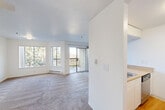 Located at 3815 Susan Drive in San Bruno, CA, this one-bedroom, one-bathroom residence offers a practical and comfortable single-floor layout. The open living area is bright and inviting, featuring large windows that flood the space with natural light and a sliding glass door that leads to a private balcony with outdoor views. Soft carpeting runs throughout the living area, lending a warm and cozy atmosphere, while a ceiling fan adds functional comfort. The kitchen is efficiently designed with white cabinetry, a countertop with an undermount sink, and stainless steel appliances, including an electric range. A half-wall partition separates the kitchen from the living area, maintaining an open and airy feel. The bedroom is a comfortable, well-proportioned retreat featuring carpet flooring, a baseboard heater, a window with a view of the surrounding greenery, and a built-in closet. A connecting hallway provides a smooth transition between the rooms. The bathroom is clean and functional, offering a single-sink vanity with a tan countertop, a toilet, and a full shower-tub combo with a curtain rod. Wood-style flooring adds a classic touch to the bathroom. Overall, the unit presents a clean, neutral palette throughout.