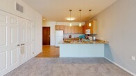 Located at 1075 Manor Dr NE in Spring Lake Park, MN, this two-bedroom, one-bathroom residence offers a well-designed single-level layout. The open-concept kitchen and living area forms the heart of the home, where warm honey-toned cabinetry, granite countertops, and a peninsula with pendant lighting create a functional and inviting space. Wood-style flooring runs through the kitchen, while plush carpeting extends into the living area, which benefits from a wide bank of windows fitted with vertical blinds that invite abundant natural light. The bedrooms are carpeted and comfortably sized, each featuring closet storage — including a spacious walk-in style closet with wire shelving — along with windows that bring in additional daylight. The primary bedroom offers a generous footprint with a dedicated closet. The full bathroom is finished with tile flooring, a vanity with wood cabinetry, and grab bars for added accessibility. Throughout the residence, neutral walls and clean lines contribute to a bright, versatile ambiance suited to a variety of décor styles. The practical layout maximizes every square foot, providing a comfortable and cohesive living environment.