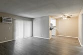 Located at 1540 W Ball Rd in Anaheim, CA, this 2-bedroom, 1-bathroom residence offers a well-organized, single-floor layout designed for comfortable everyday living. The spacious living room features light wood-look flooring, neutral beige walls, a textured ceiling, and a ceiling fan, creating a bright and airy atmosphere. A large sliding glass door floods the space with natural light and provides direct access to the outdoors, while a wall-mounted AC unit ensures year-round comfort. The kitchen is outfitted with crisp white cabinetry, sleek modern hardware, marble-look countertops, and a window with vertical blinds that brings in additional natural light. The generously sized primary bedroom is carpeted for warmth and comfort, featuring a large window with vertical blinds and a sliding-door closet with built-in hanging rods. The second bedroom is similarly appointed with carpet flooring and a sliding mirrored closet. The bathroom is clean and functional, featuring a sliding glass-enclosed shower, a marble-look vanity countertop, and tile-style flooring. A connecting hallway ties the rooms together efficiently. The overall aesthetic is fresh and neutral, offering a move-in ready space in a convenient Anaheim location.