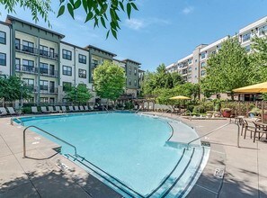 Resort style swimming pool with lounge seating - AMLI Parkside
