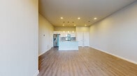 Located at 600 E North Grove Blvd in Waxahachie, TX, this well-appointed one-bedroom, one-bathroom unit offers a thoughtfully designed single-level layout. The open-concept kitchen and living area serves as the heart of the home, featuring warm wood-look vinyl plank flooring throughout, recessed lighting, and a seamless flow ideal for everyday living. The kitchen is outfitted with white shaker cabinetry, granite countertops, a tiled backsplash, stainless steel appliances including a French door refrigerator, electric range, built-in microwave, and dishwasher, as well as a central island with pendant lighting and an undermount sink. The spacious bedroom benefits from ample natural light through large windows with views of the surrounding landscaping, and connects directly to a generous walk-in closet with built-in shelving and hanging rods. The full bathroom features a dual-sink vanity with granite countertops, white cabinetry with brushed nickel hardware, a large mirror, and a separate water closet. A private outdoor patio with metal railing overlooks a manicured green space, completing this clean, modern unit in a well-maintained community setting.