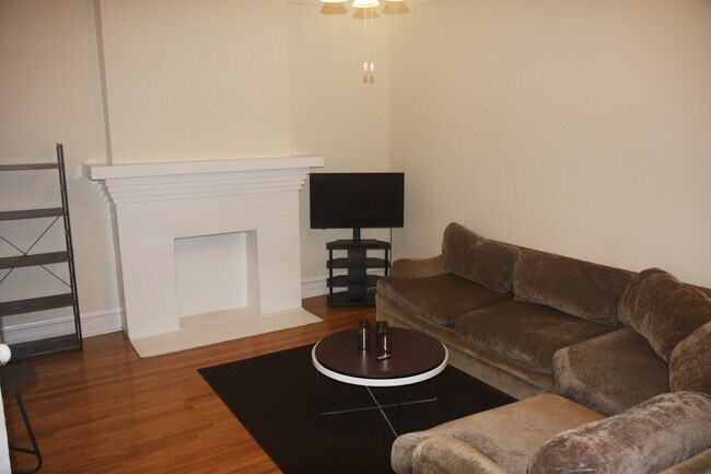 Living room view of TV and sofa. Cable modem is located in the living room - 1415 W Rosemont Ave
