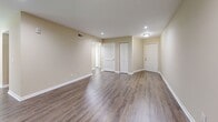 This thoughtfully designed single-floor residence offers a comfortable and functional layout comprising one bedroom, two bathrooms, two living areas, a dedicated dining room, a kitchen, a hallway, and a closet. Warm, neutral-toned walls and durable wood-look flooring flow consistently throughout the space, creating a cohesive and inviting ambiance.

The kitchen is a standout feature, showcasing white shaker cabinetry, granite countertops, and a full suite of stainless steel appliances including a range, dishwasher, and refrigerator. The adjacent dining room benefits from a large window with blinds that frames lush greenery views and fills the room with natural light, complemented by an elegant pendant light fixture.

The two living areas provide versatile spaces for relaxation and entertaining. One features sliding glass doors opening to an outdoor view, paired with a ceiling fan and recessed lighting. The bedroom is generously sized, complete with a large double-door closet and ceiling fan for added comfort.

Both bathrooms are finished with granite vanity countertops, white cabinetry, and stone-tiled surrounds, offering a clean and modern aesthetic. Throughout the home, large windows with blinds invite natural light and pleasant outdoor views, enhancing the bright and airy character of the space.