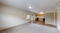 Located at 301 SE 166th Ave in Vancouver, Washington, this apartment features a thoughtfully arranged single-floor layout with three bedrooms, two bathrooms, a combined kitchen and living area, a hallway, and a closet. The kitchen is equipped with warm maple-toned cabinetry, dark laminate countertops, a double-basin sink, an electric range, dishwasher, and a full-size refrigerator, all set atop durable wood-style flooring. The open kitchen flows naturally into the living area, which features soft carpeting, neutral walls, and multiple windows fitted with blinds that allow for natural light and outdoor views of surrounding greenery. Each bedroom is carpeted and features a wall-mounted climate control unit and windows overlooking the outdoors, creating comfortable, naturally lit spaces. The primary bedroom is notably spacious, offering room for furnishings, and includes access to a closet. Both bathrooms feature wood-style flooring, a vanity with warm-toned cabinetry, a bathtub, and accessible grab bars. A wall-mounted mini-split system is present throughout the unit, providing consistent climate control. The overall ambiance is clean, neutral, and practical, making this a well-suited space for everyday living.