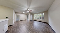 Located at 12433 Admiralty Way in Everett, WA, this one-bedroom, one-bathroom unit offers a thoughtfully designed single-floor layout that makes excellent use of its space. The living room features rich wood-style plank flooring, a ceiling fan, and large windows that invite natural light and offer pleasant views of the surrounding greenery, creating a bright and welcoming atmosphere. The galley-style kitchen is well-appointed with gray shaker cabinetry, white countertops, wood-style flooring, and a full suite of black and stainless steel appliances including a range, built-in microwave, refrigerator, and dishwasher. A dedicated closet provides convenient storage. The bedroom is carpeted for comfort, equipped with a ceiling fan, and features a window overlooking lush outdoor foliage, lending a serene, nature-connected feel. The bathroom includes a full tub-shower combination with grab bars and wood-style flooring, rounding out the practical amenities of the unit. Neutral tones throughout the home create a clean, versatile backdrop, while the consistent use of wood-style flooring in the main living areas ties the space together cohesively.