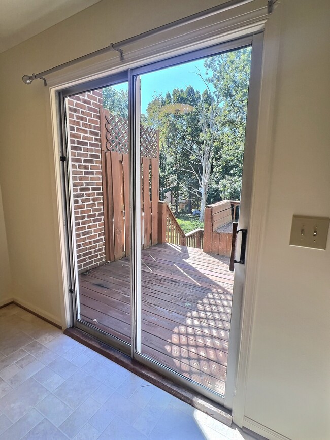 View of deck and back yard from the kitchen and eat in dining area - 69 Court Pl