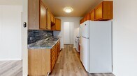 Located at 1901 Minnehaha Ave in Minneapolis, MN, this 2-bedroom, 2-bathroom unit offers a well-organized, single-floor layout designed for comfortable everyday living. The galley-style kitchen is a functional highlight, featuring warm honey-toned cabinetry, granite-look countertops, a blue tile mosaic backsplash, and wood-look vinyl plank flooring. White appliances including a gas range and full-size refrigerator are included, and the kitchen opens toward the living area, which is equipped with a ceiling fan. Both bedrooms are carpeted and bright, each featuring a ceiling fan and windows that let in natural light with city views. The spacious primary bedroom offers generous room to furnish, while the second bedroom provides a comfortable secondary space. Four closets throughout the unit offer ample storage. The two bathrooms are finished with clean white square tile, including full tub-shower combinations, illuminated vanity mirrors, and built-in cabinetry. A hallway connects the bedrooms and bathrooms, creating a practical flow throughout the home. This unit is situated in the Minnehaha neighborhood of Minneapolis, offering convenient access to local amenities.