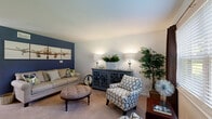 Located at 5600 Dorchester Rd in North Charleston, SC, this two-story, 2-bedroom, 2-bathroom home offers a practical and comfortable layout spread across two floors. The main level features an open living room with carpet flooring, a bold navy accent wall, and natural light from a large front window — creating a warm, inviting atmosphere. Adjacent to the living area, the kitchen is well-equipped with dark cabinetry, stainless steel appliances including a refrigerator, range, and built-in microwave, a tile backsplash, and warm hardwood-style flooring. A hallway on the main level provides convenient access to one of the two full bathrooms, which features hardwood-style flooring and a tub-shower combo. Upstairs, a staircase leads to two carpeted bedrooms and a second full bathroom. The primary bedroom offers a comfortable footprint with a window for natural light. The second bedroom is cozy and well-proportioned, featuring a ceiling fan. The second bathroom is bright with clean white finishes. The layout is efficient and functional, making this home a great fit for those seeking a well-organized, multi-level living space in the North Charleston area.