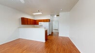 Located at 2722 Frankford Ave in Lubbock, TX, this single-floor unit offers a well-organized layout that makes efficient use of its space. The combined kitchen and living area forms the heart of the home, featuring warm hardwood-look flooring that extends throughout the main living spaces. The kitchen is equipped with rich, warm-toned wood cabinetry that wraps around the perimeter, offering generous storage. Light countertops provide ample workspace, complemented by a double-basin sink, a dishwasher, a range, a built-in microwave, and a full-size refrigerator. A raised breakfast bar peninsula defines the boundary between the kitchen and the living area, creating a natural flow between the two spaces. The living area benefits from a front-facing window dressed with blinds, allowing natural light to brighten the room. The bedroom is a comfortable, well-proportioned space finished with soft carpeting underfoot and a ceiling fan overhead. A window with blinds lets in natural light while maintaining privacy. The bedroom features access to a dedicated walk-in closet, providing practical storage. Clean white walls and crisp trim throughout the unit create a bright, neutral backdrop well-suited for a variety of furnishing styles.