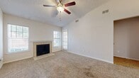 This compact yet well-designed apartment in Altamonte Springs, FL, maximizes its 570 square feet of living space. The single-story layout features one bedroom measuring 150 square feet, providing ample space for rest and relaxation. The apartment boasts a modern bathroom with a sleek white tile surround and wood-look flooring.

The heart of the home is an open-concept kitchen and living area. The kitchen is equipped with stainless steel appliances and white cabinetry, creating a clean and contemporary aesthetic. A small peninsula separates the kitchen from the carpeted living space, which includes a charming fireplace, adding warmth and character to the room.

Comfort and convenience are key features, with ceiling fans throughout and an in-unit laundry area complete with a washer and dryer. Large windows and a sliding glass door leading to a private balcony allow natural light to flood the space, creating an airy atmosphere and providing a connection to the outdoors.

Storage solutions include a closet in the bedroom and additional built-in storage areas. The neutral color palette of whites and beiges throughout the apartment offers a blank canvas for personal decorating styles. This efficient apartment combines functionality with modern amenities, making it an ideal space for comfortable single living or a cozy home for a couple.