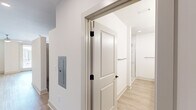 Located at 2145 Robin Lark Dr in Winston-Salem, NC, this single-floor, one-bedroom, one-bathroom residence offers a thoughtfully designed layout with contemporary finishes throughout. Light-toned luxury vinyl plank flooring runs seamlessly across every room, complementing the clean white walls and recessed lighting that give the space a bright, airy feel.

The open-concept kitchen is a standout feature, centered around a granite-topped island with an undermount sink and pendant lighting overhead. White shaker-style cabinetry reaches toward the ceiling for ample storage, while a white tile backsplash and full suite of stainless steel appliances — including a range, over-the-range microwave, and French door refrigerator — complete the modern aesthetic. A pantry closet sits conveniently adjacent to the kitchen.

The living area flows naturally from the kitchen, offering an open and versatile space with recessed lighting and easy access to the entry hallway. The bedroom is a comfortable, well-proportioned retreat featuring a ceiling fan, natural light from a window, and double panel doors leading to a dedicated closet with built-in shelving.

The bathroom is notably spacious, offering a long granite-topped vanity with dual sinks, a large mirror, brushed gold fixtures, a glass-enclosed shower, and wood-look flooring that ties the design together cohesively.
